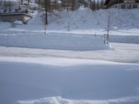 an outdoor view of a resort during the day in the snow, with a slope to the left
