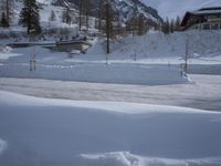 an outdoor view of a resort during the day in the snow, with a slope to the left