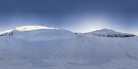 an snow boarder in blue and red jacket is skiing on a snow covered hill