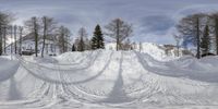 a picture of a big snowy hill with many tracks going in front of it,