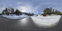 the snow covered mountains are reflected in a pair of spherical views of the road and snow