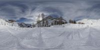 a mountain covered in snow and trees with white clouds behind it that can be seen on a webcam