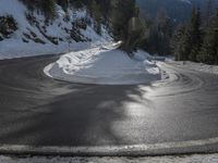 snow on the road, and the bright sunlight casting shadows off the ground and snow in front