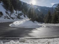 snow on the road, and the bright sunlight casting shadows off the ground and snow in front