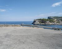 a paved road beside some large boats and a bridge with a bridge to the water