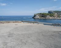 a paved road beside some large boats and a bridge with a bridge to the water