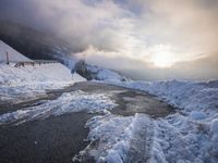 a road with a road side in the winter on top of it is covered by snow