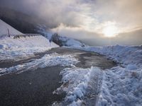 a road with a road side in the winter on top of it is covered by snow