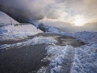 a road with a road side in the winter on top of it is covered by snow