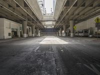 an empty parking lot surrounded by high rise buildings in the city with street signs and traffic