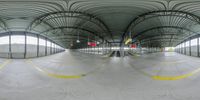 a fish eye view looking up at the ground and walkway area inside the building with double exposurers