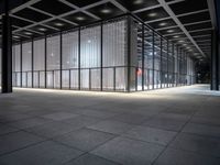 empty building with large windows that have lights coming from them and in between the floor