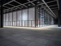 empty building with large windows that have lights coming from them and in between the floor