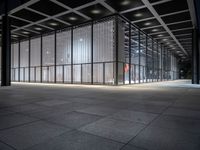 empty building with large windows that have lights coming from them and in between the floor