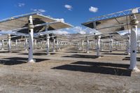 a row of solar panels on the ground of a solar park in the desert setting