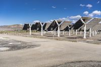 a row of solar panels on the ground of a solar park in the desert setting