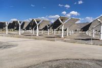 a row of solar panels on the ground of a solar park in the desert setting