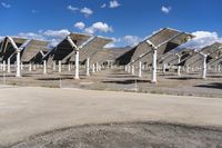 a row of solar panels on the ground of a solar park in the desert setting