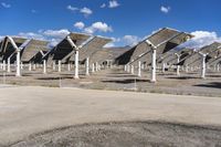 a row of solar panels on the ground of a solar park in the desert setting