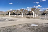 a row of solar panels on the ground of a solar park in the desert setting