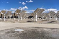 a row of solar panels on the ground of a solar park in the desert setting