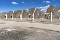 a row of solar panels on the ground of a solar park in the desert setting