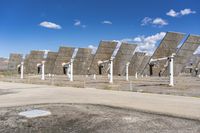 a row of solar panels on the ground of a solar park in the desert setting