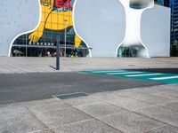 a woman on a phone sitting in front of a large white sculpture in the city