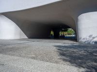 a skateboarder is attempting to do a trick on the sidewalk in front of a large white building