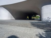 a skateboarder is attempting to do a trick on the sidewalk in front of a large white building