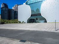 a person on a skateboard in front of a building that has a green apple shaped design