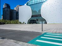 a person on a skateboard in front of a building that has a green apple shaped design