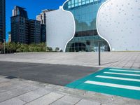 a person on a skateboard in front of a building that has a green apple shaped design