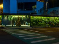 the street has many lights, trees, and other decorations on it at night time