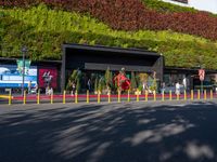 the outside of this shopping center is full of plants and animals in many colors of red