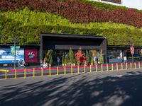 the outside of this shopping center is full of plants and animals in many colors of red