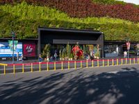 the outside of this shopping center is full of plants and animals in many colors of red