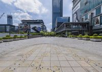 there is a paved path in a very city setting with buildings and blue sky above