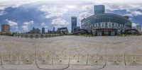 a city and the building seen through a fisheye lens lens while you can see the reflection