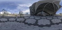 a 360 - shot of a view of the structure of a modern building, with several geometric flowers arranged on its floor