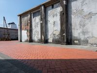 an empty building sitting in front of two tall pillars with peeling concrete panels attached to the side