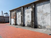 an empty building sitting in front of two tall pillars with peeling concrete panels attached to the side