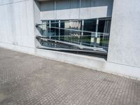 the reflection of the building behind the bench is very reflective in this picture, which makes the shadow look small