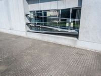 the reflection of the building behind the bench is very reflective in this picture, which makes the shadow look small