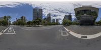 three dimensional image of an empty street with buildings on both sides of the street and trees in the background