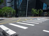 crosswalk at the corner of a street with buildings in the background with yellow lines