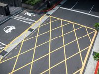 the parking lot is marked with yellow lines on the pavement at the crosswalks