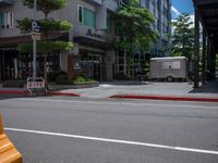 a street scene in the daytime with an old fashioned trailer parked at an empty curb