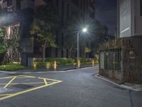 night time picture of parking lot with parking meter in the background on a street corner