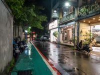 motorcyclists and pedestrians on a city street during the rainy night time and rain